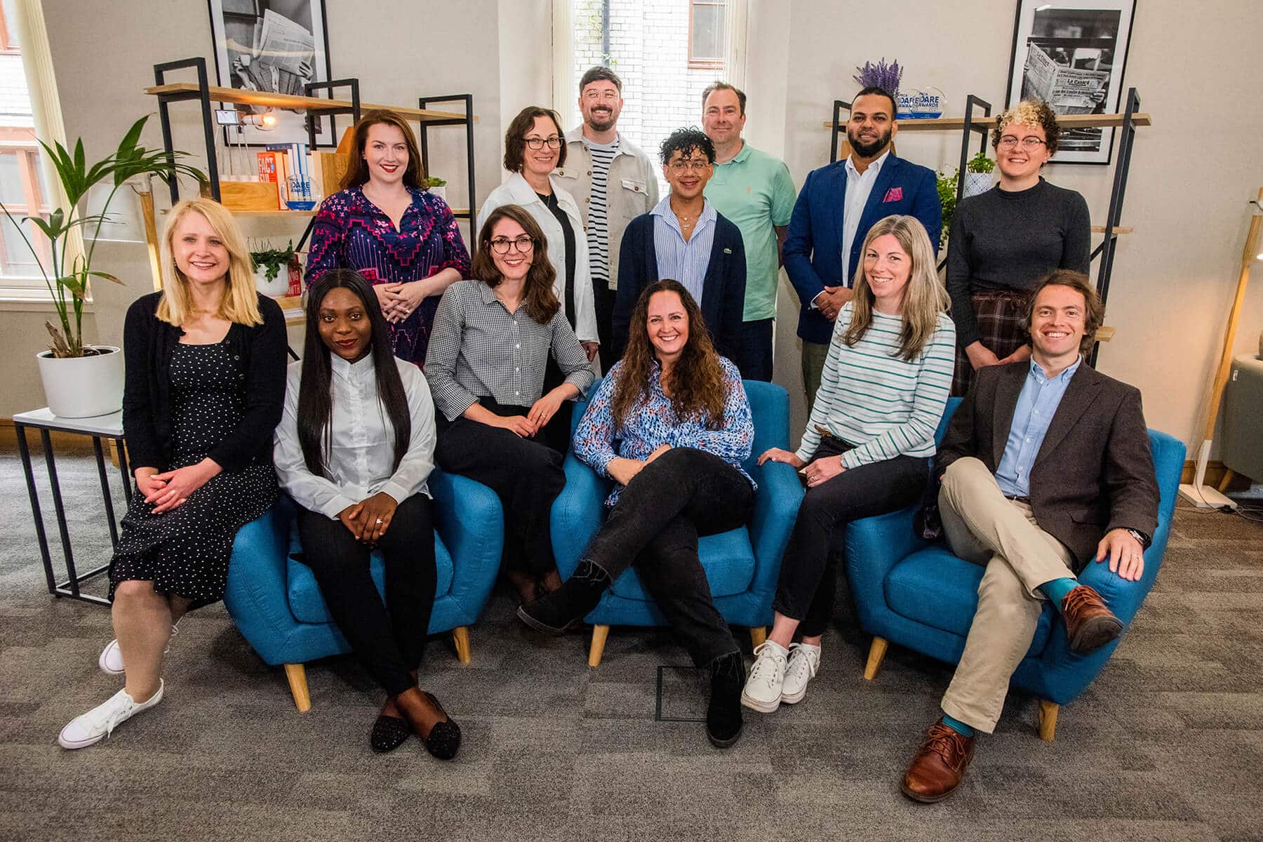 Image of the Hot Tin Roof Team, Edinburgh based PR Agency in an office environment all looking at the camera who tell the stories that need to be heard on the About Us page
