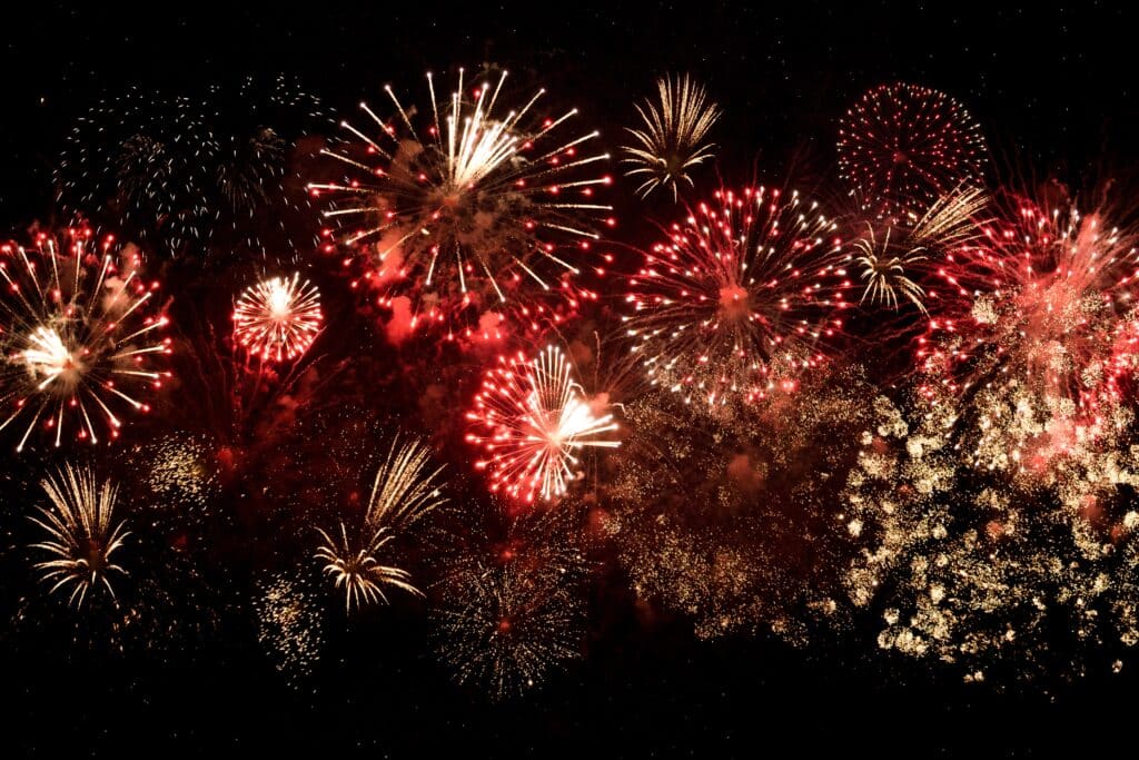 Red and Gold fireworks across a night sky.