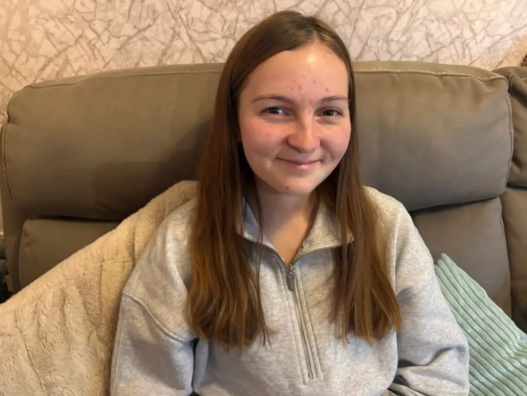 Emily, aged 20 from Kinloss in Moray, smiling at home, a young woman living with Type 1 Diabetes who uses the DigiBete app for diabetes management and education