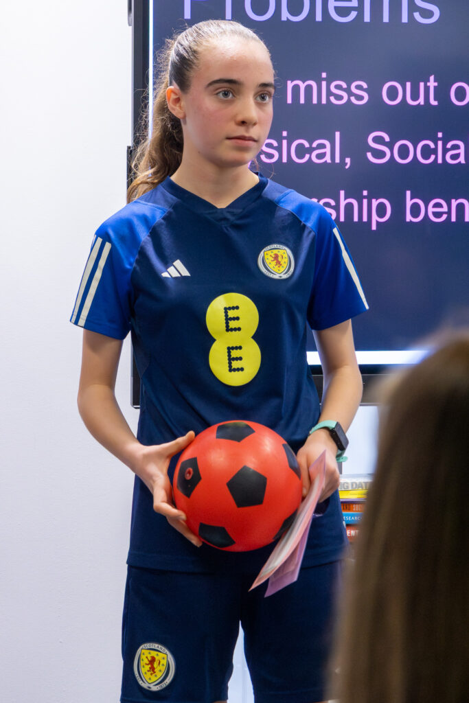 Maya Barcella TrainHer app creator in Scotland football kit with football