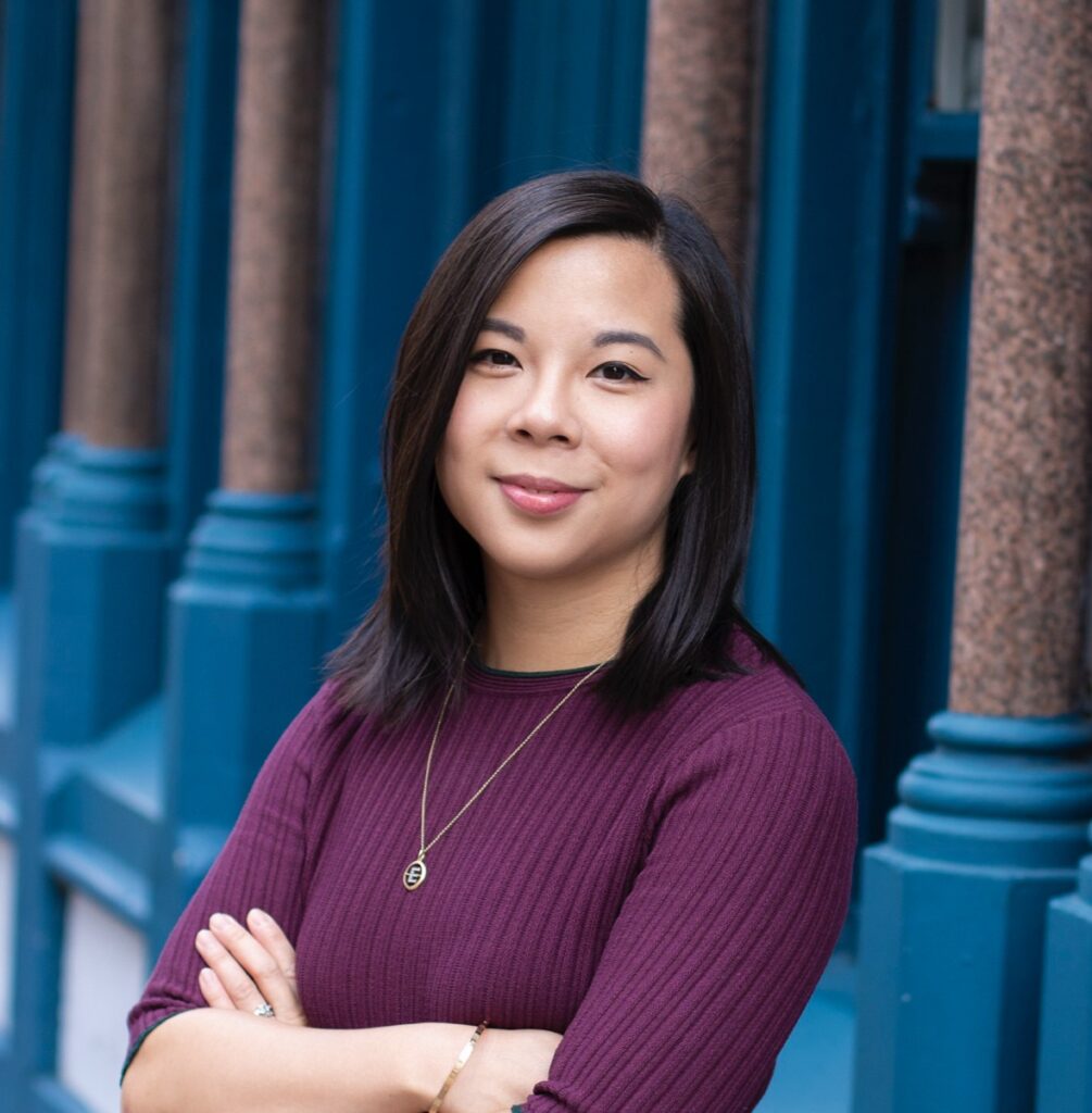 Eleanor Tang-Smith, Co-Founder and COO of OLO Robotics, photographed outdoors in front of teal-painted columns, representing the Sheffield-based robotics startup's commercial launch and its mission to make ROS2-based robotics development accessible to mainstream software developers and domain experts